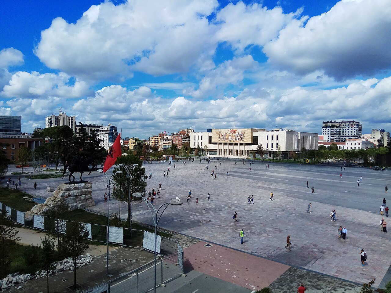 https://overlandtraveltips.com/wp-content/uploads/2026/08/1280px-Skanderbeg_square_from_the_Municipality_building_rooftop.jpeg