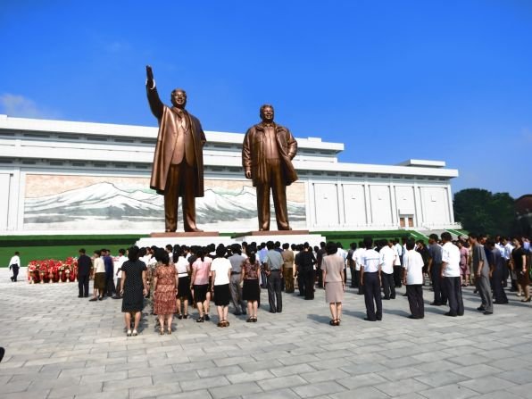 https://overlandtraveltips.com/wp-content/uploads/2026/08/131202121054-5-north-korea-tourism-kim-statues.jpg