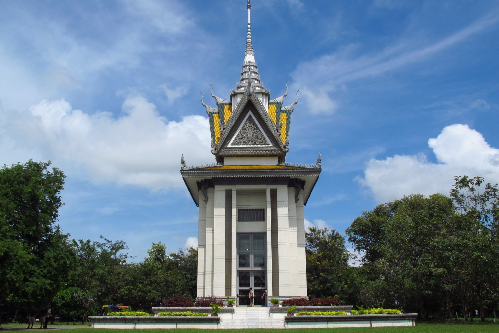 https://overlandtraveltips.com/wp-content/uploads/2026/08/Buddhist_Stupa_at_Choeung_Ek_killing_fields2C_Cambodia.JPG