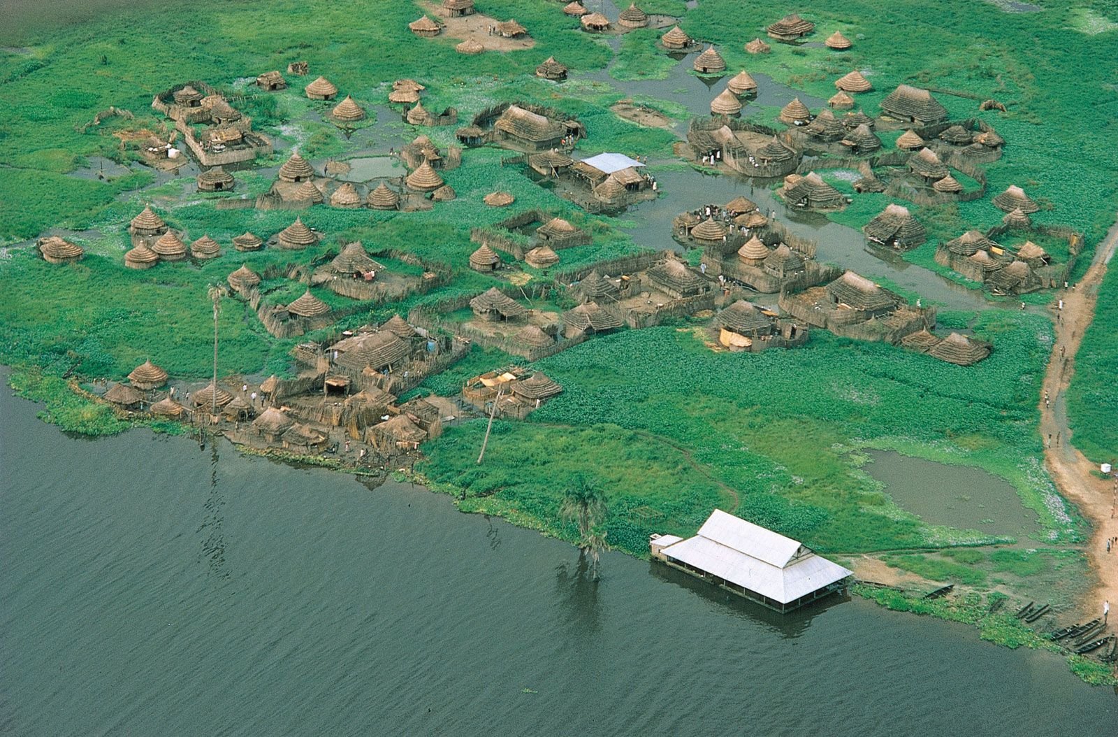 https://overlandtraveltips.com/wp-content/uploads/2026/08/Village-White-Nile-River-Al-Sudd-South-Sudan.jpg