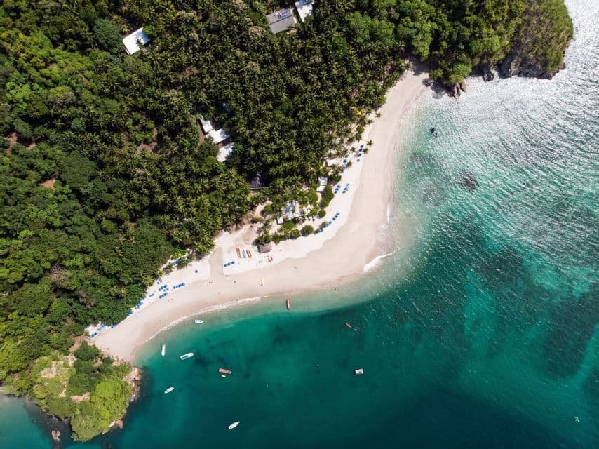 https://overlandtraveltips.com/wp-content/uploads/2026/08/aerial-view-tropical-beach-jungle.jpg