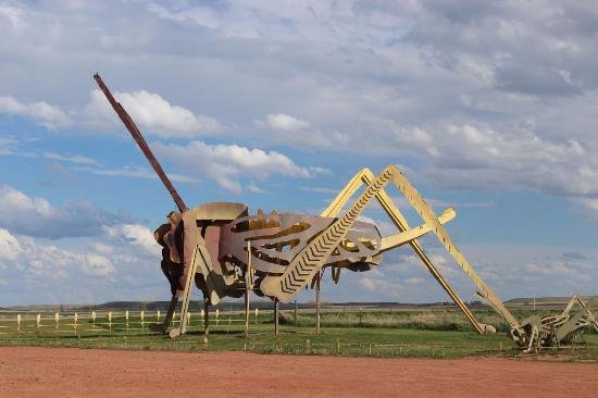 https://overlandtraveltips.com/wp-content/uploads/2026/08/giant-metal-grasshopper.jpg
